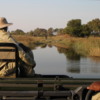 On safari, Sandibe Concession, Botswana: Driving through a flooded channel.