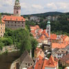 Ceský Krumlov -- town overview: The castle tower is seen in the upper left. The River Vltava surrounds most of the town in the shape of an exaggerated letter "S"