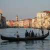 Venice -- crossing the Grand Canal by Traghetto: The traghetto allow people to cross the Grand Canal at a few locations (where no bridges exist). It is an inexpensive form of transit &amp; a cheap "gondola ride". Locals usually stand; tourists seem to like to sit