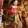 Pinocchio riding a tricycle, Woodcarver's shop, Florence, Italy