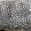 Triple swirl design at the entrance to the tomb is of unknown significance