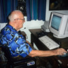 Arthur C. Clarke as I often remember seeing him.: An e-mail addict, sitting at his desk dealing with "the global village" he'd envision many years earlier