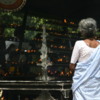 Anuradhapura -- Bodhi tree: Pilgrims burning incense and praying
