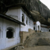 Dambulla -- Cave Temples: The white walls built beneath the overhang lead to a complex of five caves, each with its unique entrance.