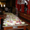 Kandy --Pilgrims praying at the Temple of the Tooth: Note the large number of floral offerings and praying pilgrims. The place the tooth relic is stored is immediately in front of these people.
