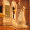 Jodphur Mehrangarh fort window: A palace guard glances from the window