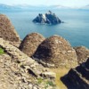 Skellig Michael, beehive cells and Small Skellig.  Courtesy of Arian Zwegers, Wikimedia
