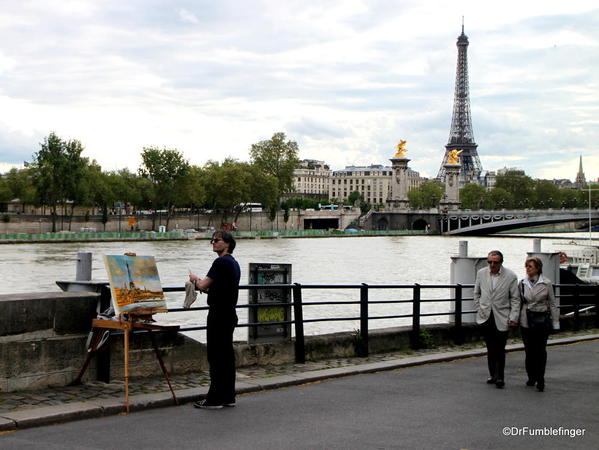 Street artist by the Seine, painting the Eiffel Tower