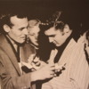 Elvis Presley and Carl Perkins signing autographs