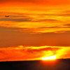 Calgary skies 01 Sunrise.  Plane taking off into sun.