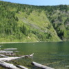 Lower Stevens Lake, Idaho: Surrounded by the Bitterroots. Logs are washed onto the southern shore of the Lake