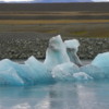Jokulsarlon, Iceland: Ghostly procession of luminous blue icebergs as they drift out to sea.