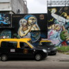 Street art on the walls of a power plant in the Colegiales barrio.: Note all the "Radio Taxis".  A cheap and safe way to get around Buenos Aires.