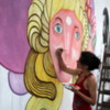 Artists creating street art on Charcarita walls.