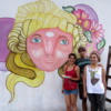 Three street artists creating street art on Charcarita walls.