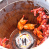 Thai street food-11: chickens hung around the inside of a clay pot with a slow fire at the bottom.