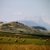 Southern Alberta -- the transition between the great plains and Rocky Mountains. Large bales of hay had just been cut