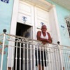 Casa Particulares in Cuba: Welcoming family member at the unassuming entrance to Hostal el Tayaba, Trinidad de Cuba