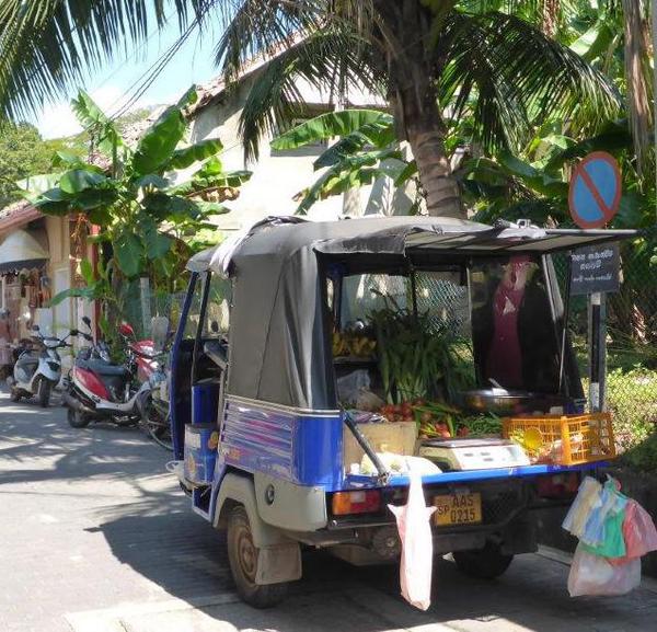 Vegetables being sold from a car, Galle