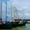 Sailing vessels are moored in Volendam's harbor