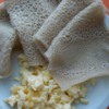 Injera with scrambled eggs.  The injera is used to grasp the egg