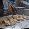 Fresh Fish, speared and dunked into boiling oil