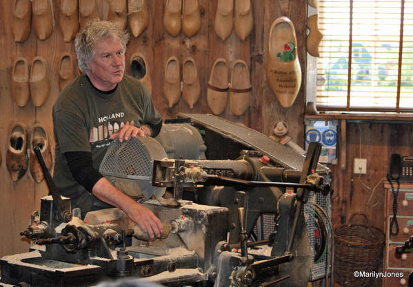 A craftsman shows how clogs are made on a century-old machine. First they are shaped