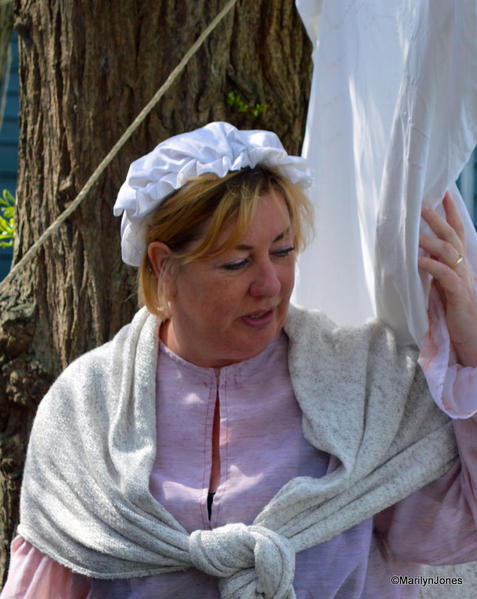 Costumed interpreters go about their chores as if it was the 17th or 18th century