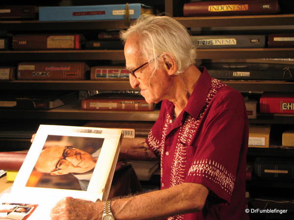 Hans Monheimus in his photoroom, looking at one of his portraits of Arthur C. Clarke