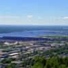 View from Enger Tower: Looking southeast, we see the city of Duluth, iron ore docks, the St. Louis River, The Richard I. Bong Memorial Bridge (Highway 2) which also connects Duluth Minnesota to Superior Wisconsin.