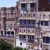Town houses, Sana’a Yemen made from stone and largely mud and cement then limewashesd around windows and doors to deter insects. The top floor is the mafraj
