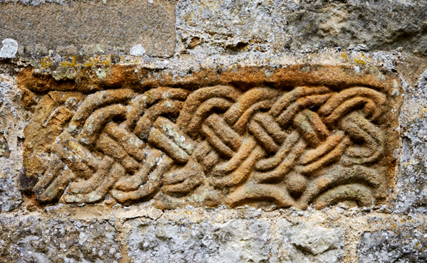 An ancient carving set in the minster exterior wall.