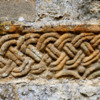 An ancient carving set in the minster exterior wall.: Typical  Viking or Anglo-Saxon type rope carving.
