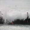 Getting drenched.  And often washed off the breakwater wall.  Waikiki Beach