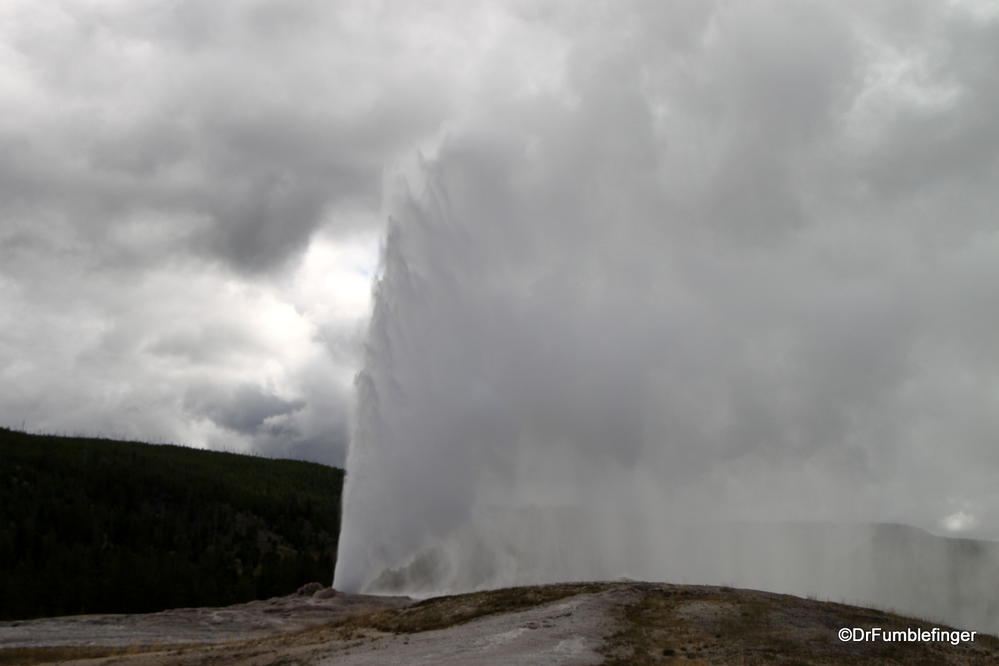 Old Faithful Geyser erupting on a cloudy day, Yellowstone National Park