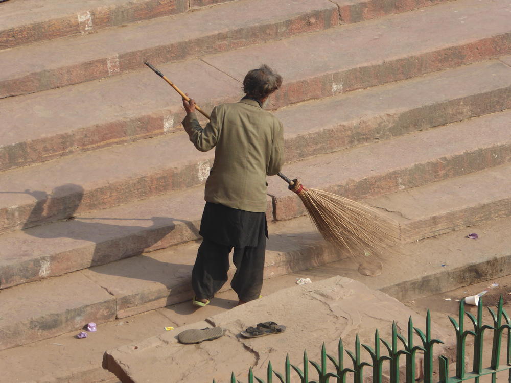 Sweeping the steps of the  Jama Jasjid, Old Delhi