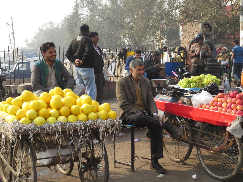 Produce vendors at a market in Old Delhi