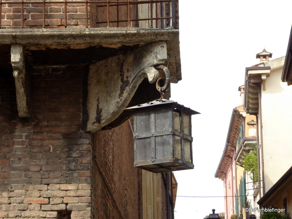 That's a very old lamp on an old building.  Verona